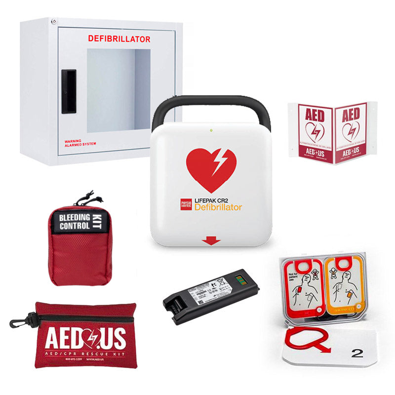 Collection of emergency medical supplies including a defibrillator, bleeding control kit, and AED US branded items on a white background.